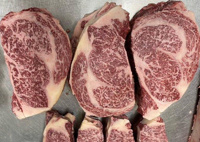 A5 wagyu ribeyes on a butcher's table