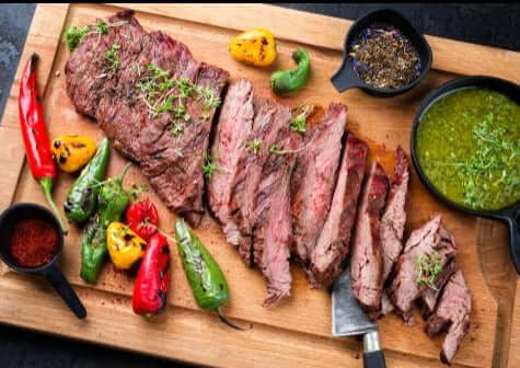 wagyu bavette steak sliced on a board with condiments