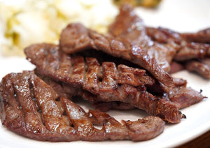 several beef tongue grilled on a plate